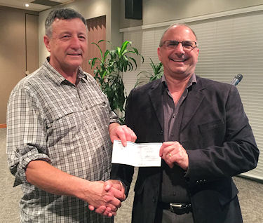 Sunday Line director, Ron Marriott (left) delivers cheque to  Sergio Bersaglio, director of Villages of Hope Africa